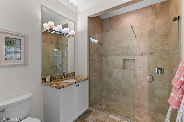 bathroom with crown molding, a shower with door, vanity, and toilet