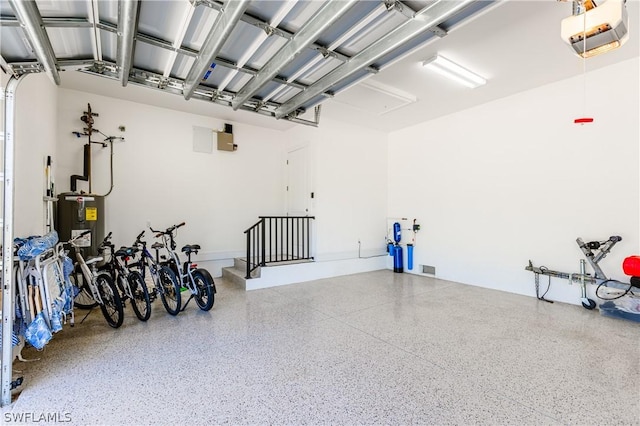 garage featuring electric water heater and a garage door opener