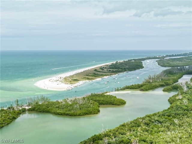 bird's eye view featuring a water view and a view of the beach