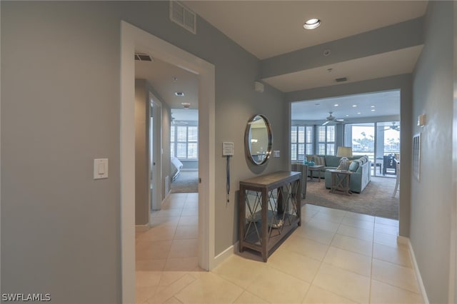 hallway featuring light tile floors