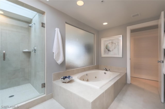 bathroom featuring plus walk in shower and tile floors