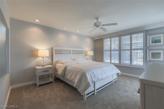 bedroom with ceiling fan and dark carpet