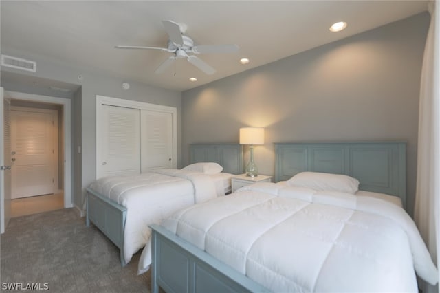 bedroom with a closet, ceiling fan, and dark carpet