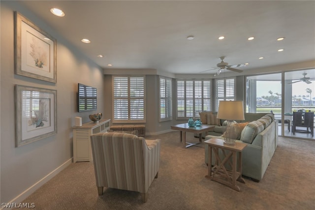 living room with plenty of natural light, carpet floors, and ceiling fan