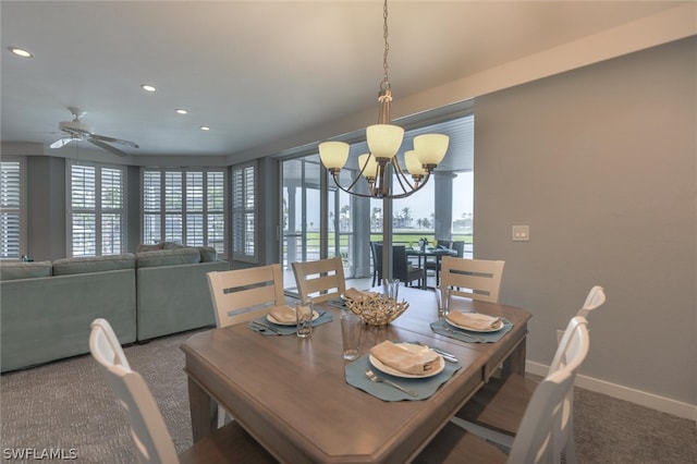 carpeted dining space featuring ceiling fan with notable chandelier