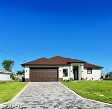 view of front of home featuring a front lawn and a garage