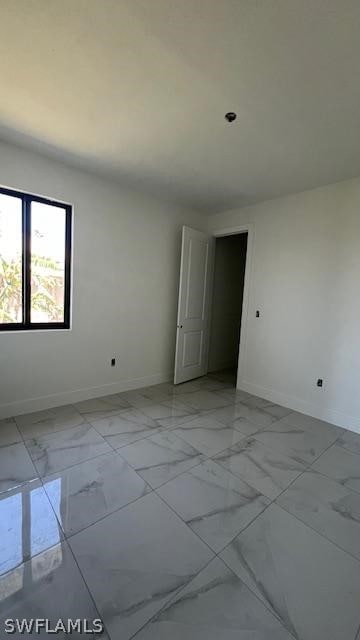 unfurnished room with light tile floors