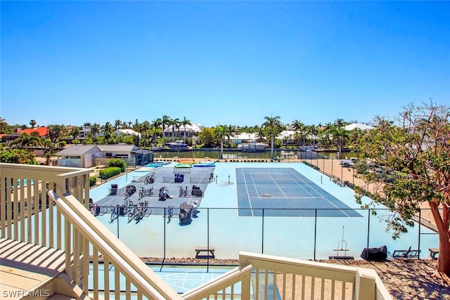 exterior space featuring a swimming pool and a water view