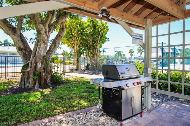 view of terrace featuring a community pool and grilling area