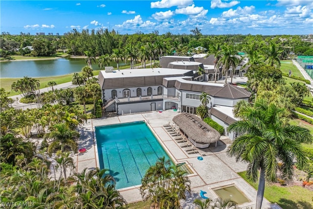 view of swimming pool featuring a patio and a water view