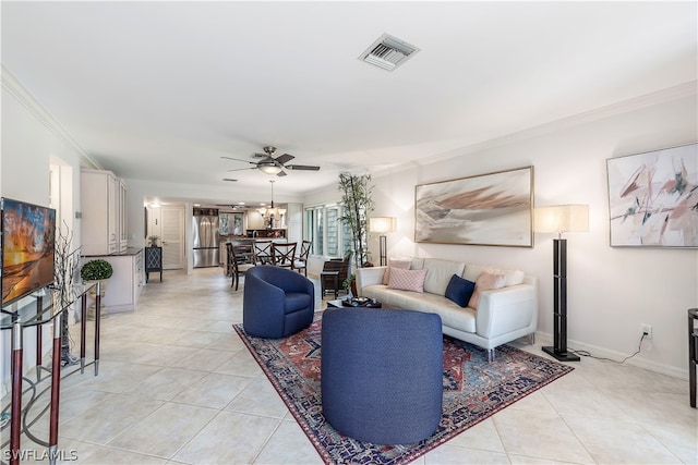 tiled living room with ceiling fan and crown molding