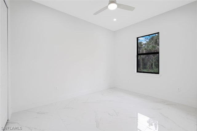 unfurnished room featuring tile patterned flooring and ceiling fan