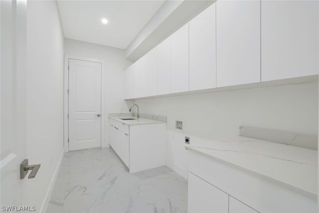 laundry area featuring sink, electric dryer hookup, cabinets, light tile patterned floors, and washer hookup