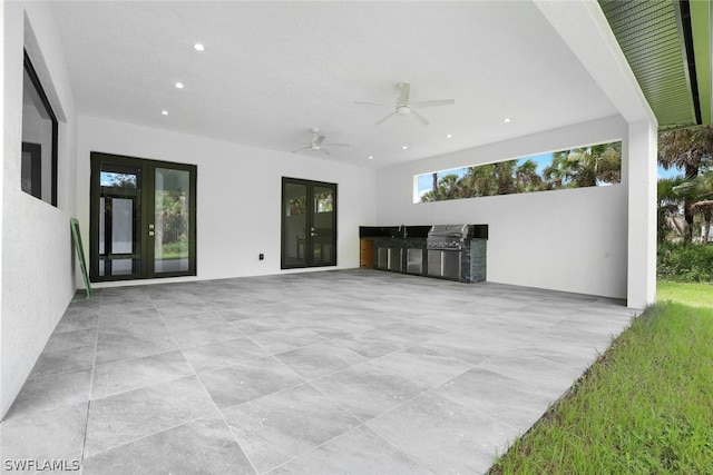 view of patio with an outdoor kitchen and ceiling fan