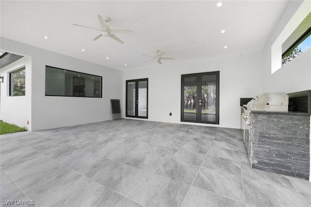 interior space featuring area for grilling, french doors, a patio area, and ceiling fan