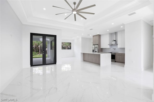 kitchen with crown molding, a raised ceiling, french doors, and light tile patterned floors