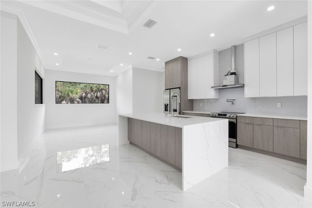 kitchen featuring appliances with stainless steel finishes, light tile patterned floors, a center island with sink, and crown molding