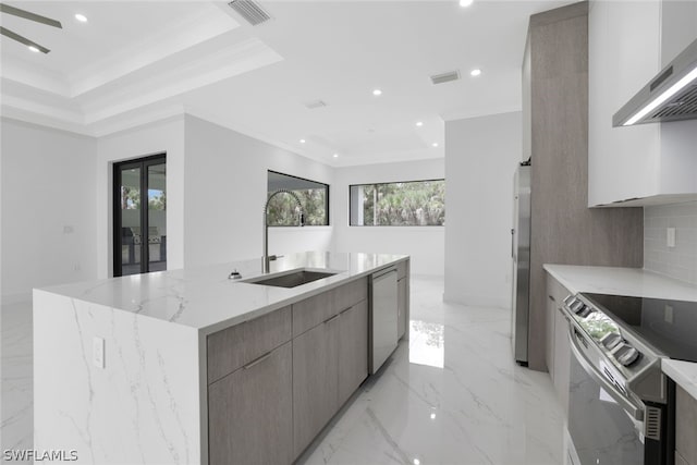 kitchen featuring sink, light tile patterned floors, plenty of natural light, and wall chimney exhaust hood