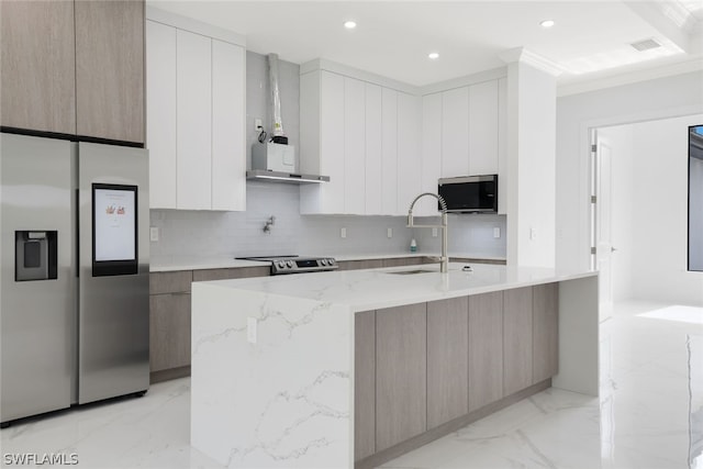 kitchen featuring light tile patterned flooring, appliances with stainless steel finishes, sink, and an island with sink