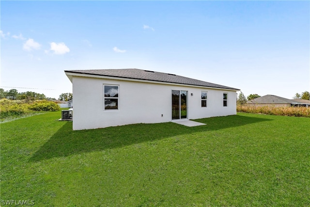 rear view of property featuring a lawn