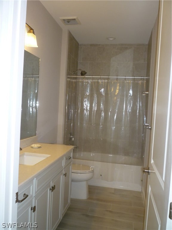 full bathroom with toilet, shower / bath combination with curtain, and vanity