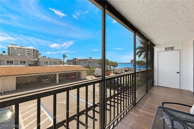 balcony featuring a water view