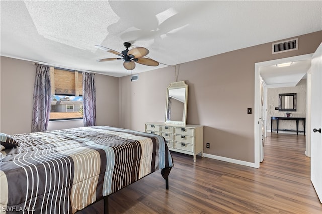 bedroom featuring a textured ceiling, hardwood / wood-style flooring, and ceiling fan