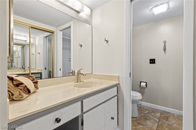 bathroom featuring vanity and toilet