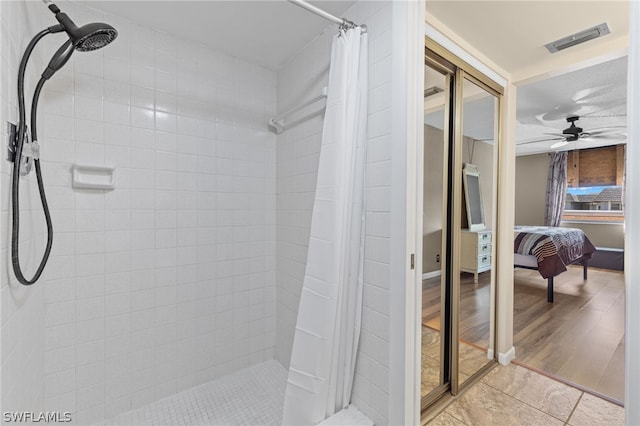 bathroom featuring a shower with curtain, ceiling fan, and hardwood / wood-style floors