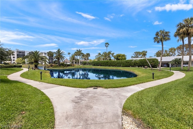 view of community with a lawn and a water view