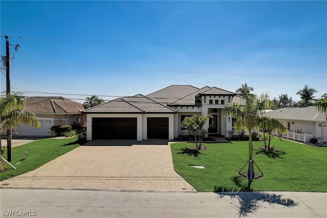 view of front of house featuring a garage and a front lawn