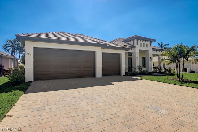 view of front of home featuring a front yard and a garage