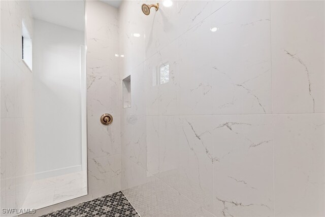 bathroom with tiled shower