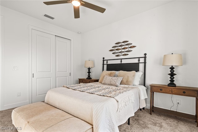 carpeted bedroom with ceiling fan and a closet