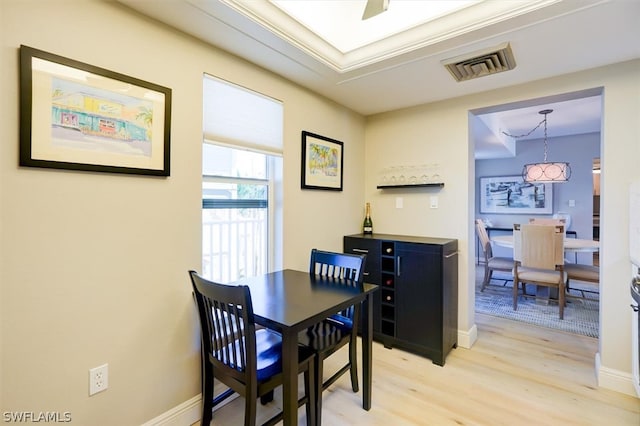 dining space featuring ornamental molding and hardwood / wood-style floors