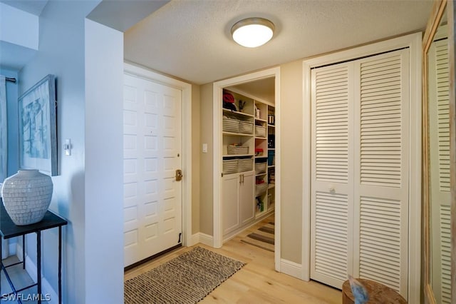 interior space featuring a textured ceiling and light hardwood / wood-style flooring