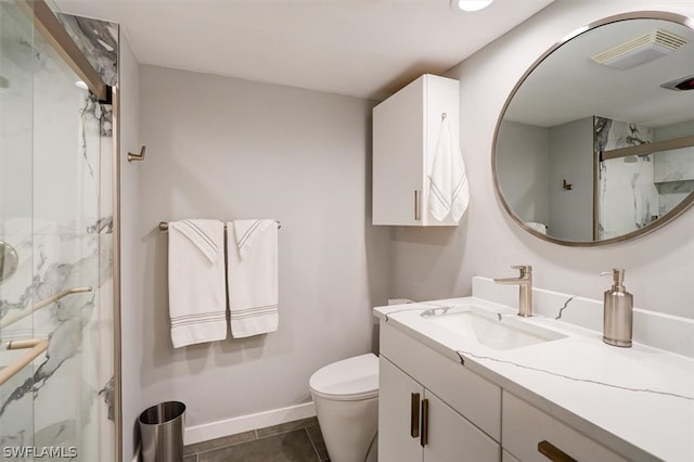 bathroom featuring toilet, vanity, tile patterned flooring, and walk in shower