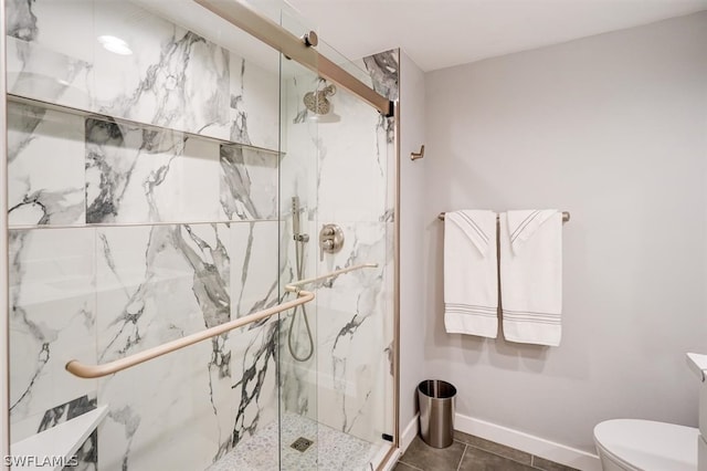 bathroom featuring walk in shower, tile patterned flooring, and toilet