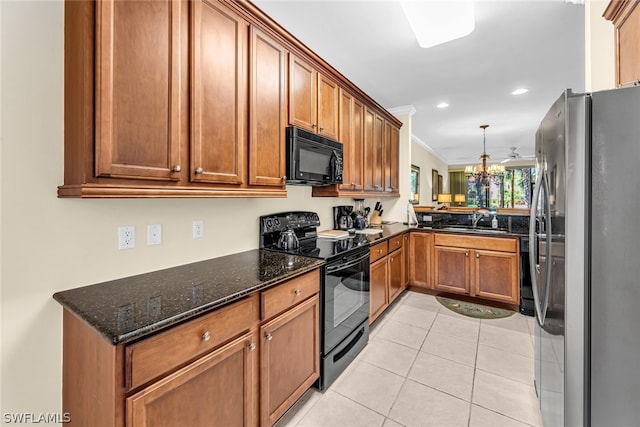 kitchen featuring a chandelier, light tile flooring, dark stone counters, ornamental molding, and black appliances