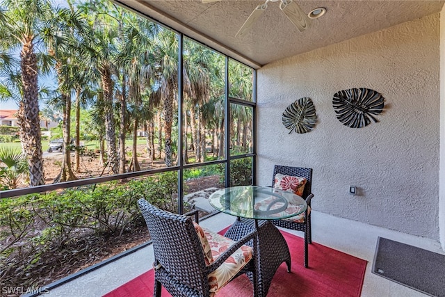 sunroom featuring ceiling fan