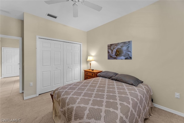 bedroom featuring light carpet, a closet, and ceiling fan