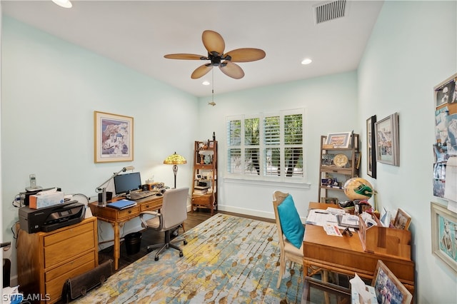 office area with ceiling fan and dark wood-type flooring