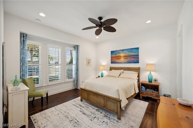 bedroom with dark hardwood / wood-style flooring and ceiling fan