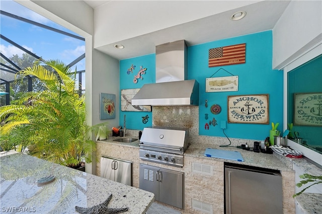 kitchen featuring refrigerator, tasteful backsplash, wall chimney exhaust hood, and light stone countertops