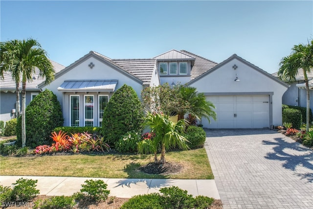 view of front of home featuring a garage and a front lawn