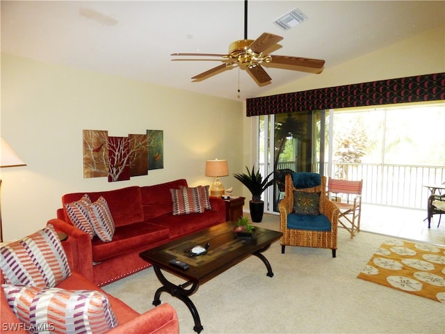 living room with lofted ceiling, light colored carpet, and ceiling fan