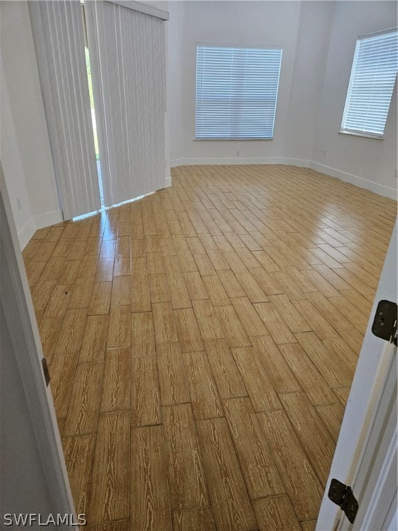 unfurnished room with hardwood / wood-style floors