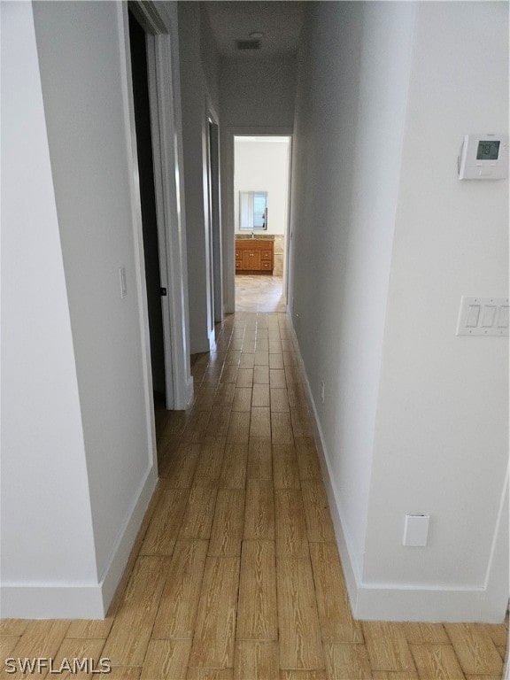 corridor with wood-type flooring