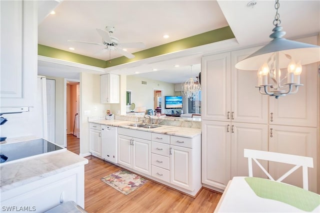 kitchen featuring dishwasher, white cabinetry, and hanging light fixtures