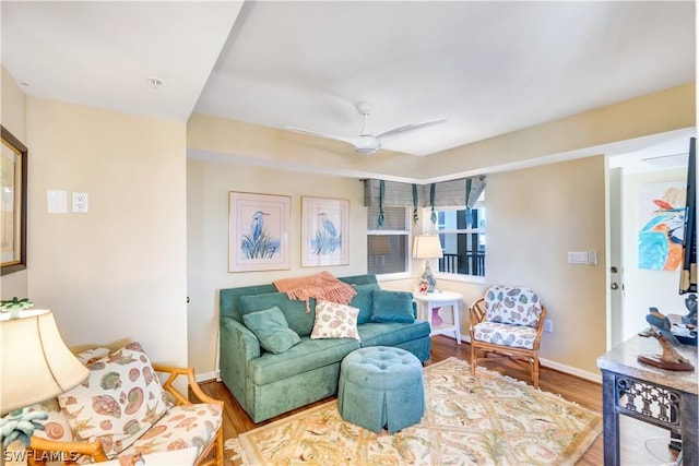 living room featuring wood-type flooring and ceiling fan